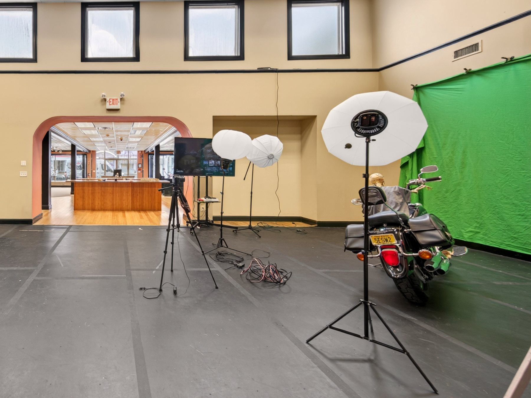 Video production floor with green screen, cameras, studio lighting, and motorcycle at 219 Studios